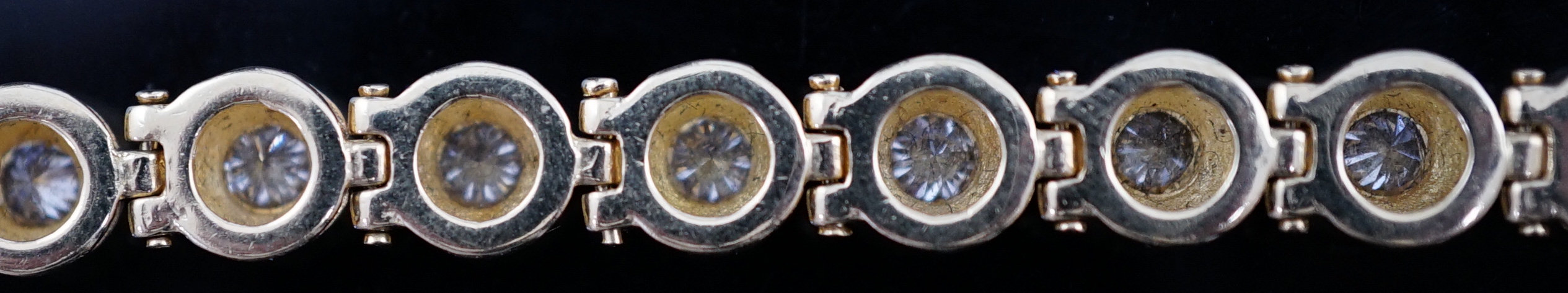 A modern 18ct gold and twenty six round brilliant cut diamond set line bracelet